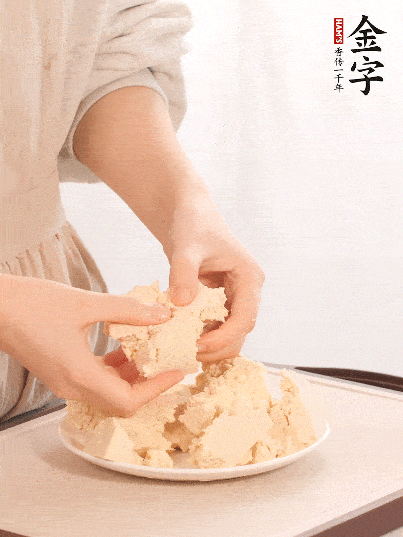 老豆腐用手掰成塊。